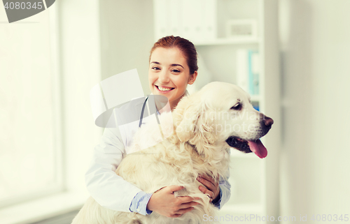 Image of happy doctor with retriever dog at vet clinic