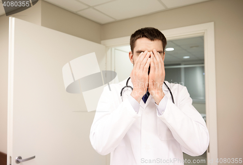 Image of sad or crying male doctor at hospital ward