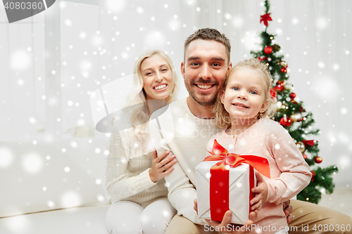 Image of happy family at home with christmas gift box