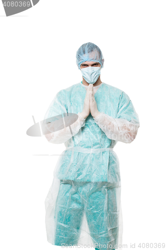 Image of Surgeon portrait. isolated on white background. focuses on reflection. fingers pyramid. praying