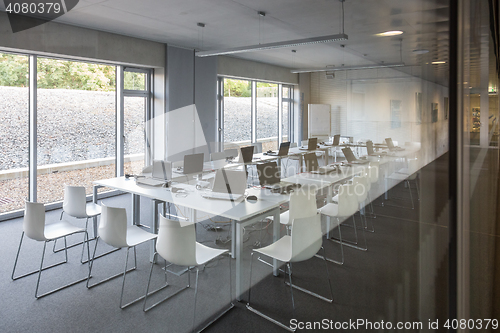 Image of Empty white chairs in contemporary conference hall with