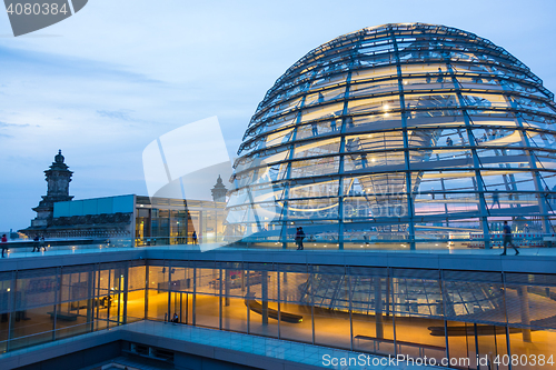 Image of Illuminated glass dome on the roof of the Reichstag in Berlin at dusk.