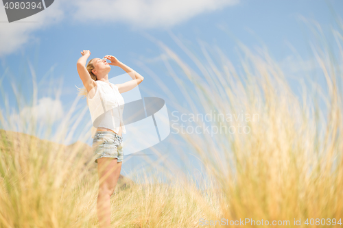 Image of Free Happy Woman Enjoying Sun on Vacations.