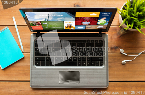 Image of close up of laptop computer on wooden table