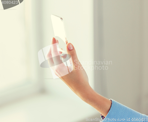 Image of close up of woman with transparent smartphone