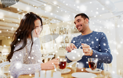 Image of happy couple drinking tea at cafe