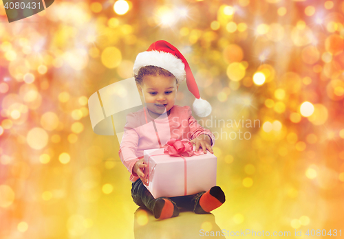 Image of happy little baby girl with christmas present