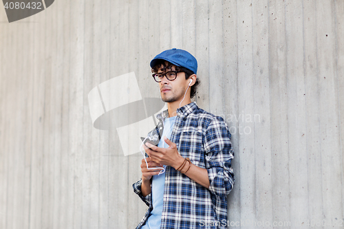 Image of man with earphones and smartphone listening music