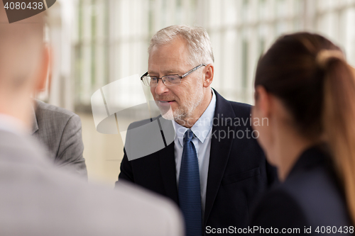 Image of smiling business people meeting in office