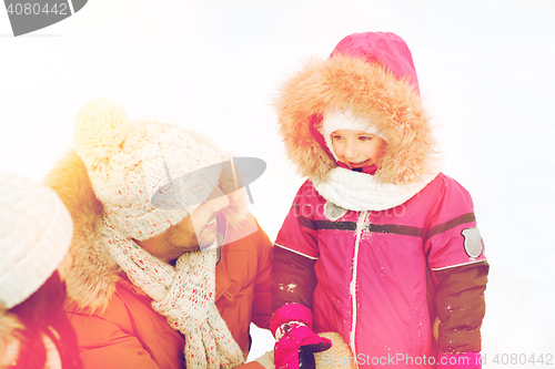 Image of happy family with child in winter clothes outdoors