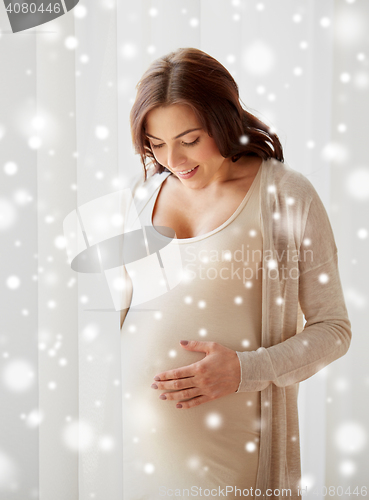 Image of happy pregnant woman with big tummy at home