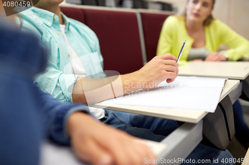 Image of group of students with notebooks at lecture hall