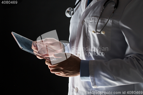 Image of close up of doctor with tablet pc and stethoscope