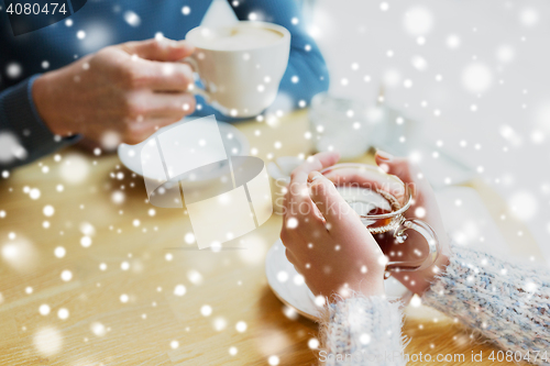 Image of close up of couple drinking tea at cafe