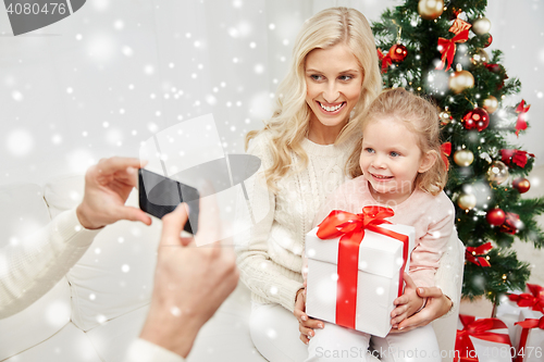 Image of family taking picture with smartphone at christmas