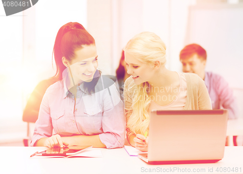 Image of students with laptop, tablet pc and notebooks