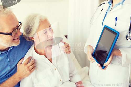 Image of senior woman and doctor with tablet pc at hospital