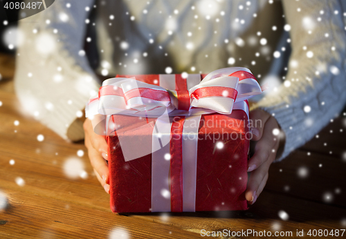 Image of close up of woman with christmas gift