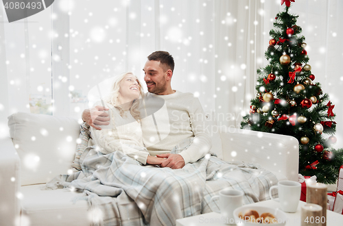 Image of happy couple at home with christmas tree