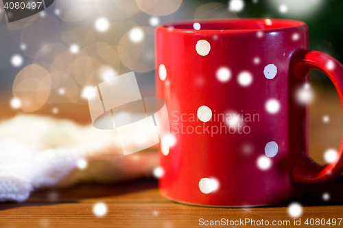 Image of red polka dot tea cup on wooden table