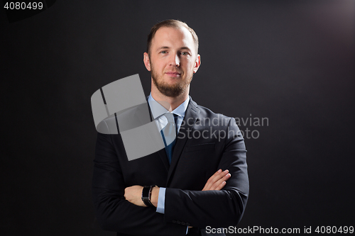 Image of happy businessman in suit over black background