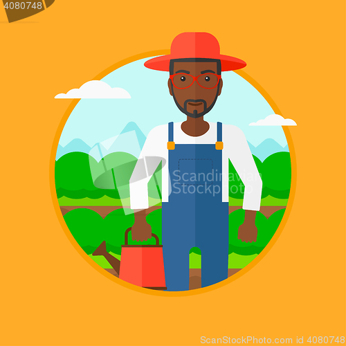 Image of Farmer with watering can at cabbage field.