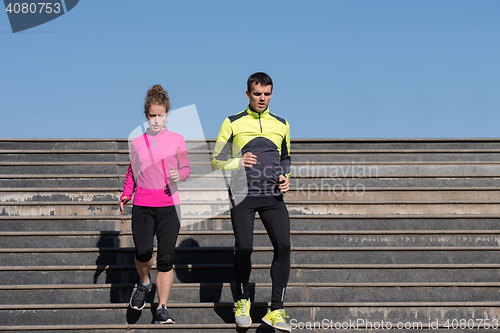 Image of young  couple jogging on steps