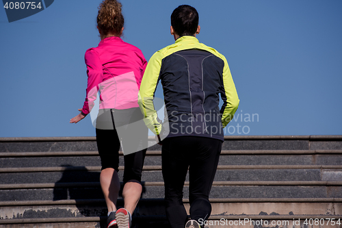 Image of young  couple jogging on steps