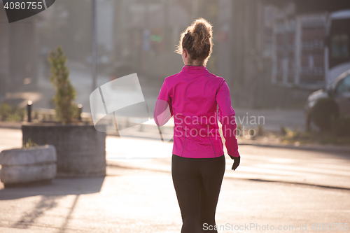 Image of sporty woman jogging on morning