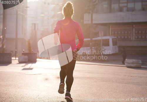 Image of sporty woman jogging on morning