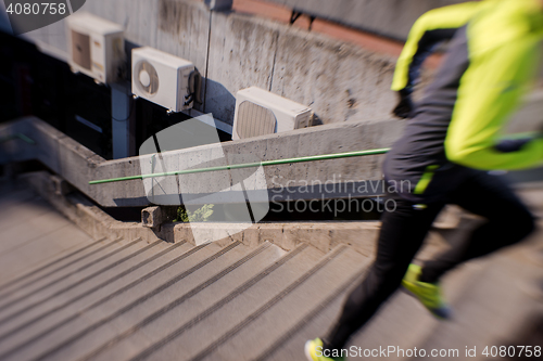 Image of man jogging on steps