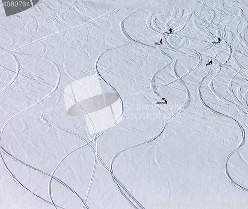 Image of Snowboarders and skiers downhill on off piste slope