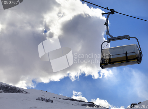 Image of Chair-lift in ski resort and blue sky with sunlight clouds at su