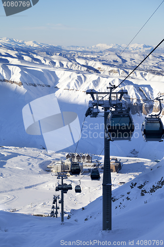 Image of Gondola lift on ski resort at sun evening