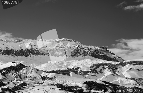 Image of Black and white snowy mountains at nice sun winter day