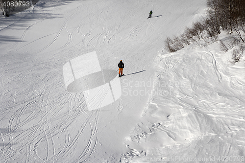 Image of Skiers on ski slope at sun winter day