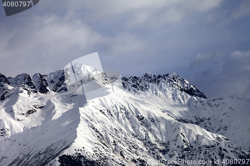 Image of Snow sunlight mountain and cloudy sky at winter evening