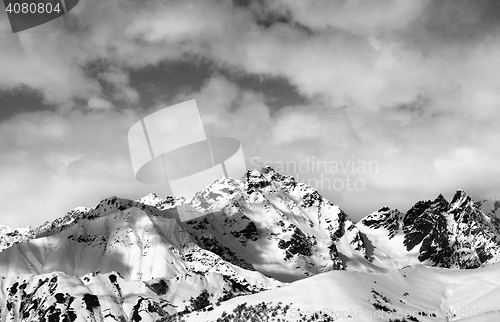 Image of Black and white snow slope and winter sunlight mountains in clou