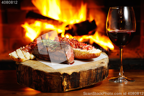 Image of tasty steak on a background of fire