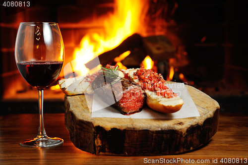 Image of tasty steak on a background of fire