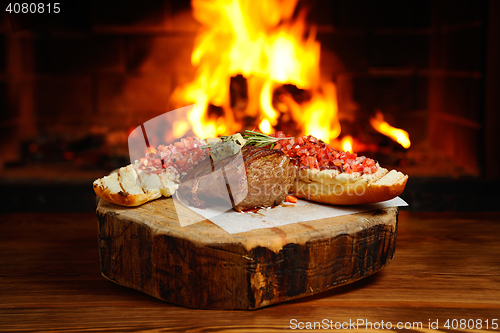 Image of tasty steak on a background of fire