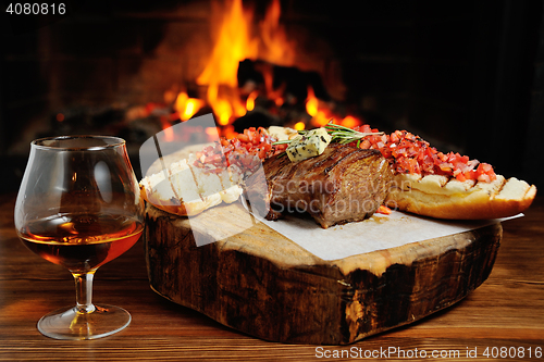 Image of tasty steak on a background of fire