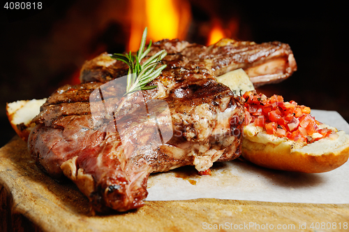 Image of tasty steak on a background of fire