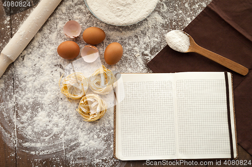 Image of Cooking some tasty food and writing down recipe.