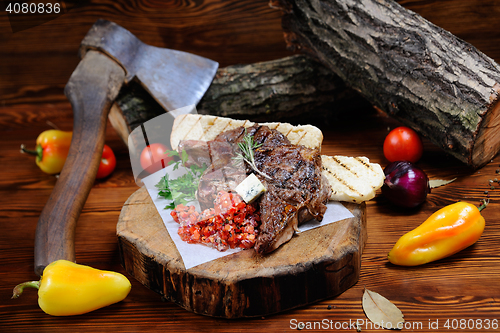 Image of juicy steak on the wooden background