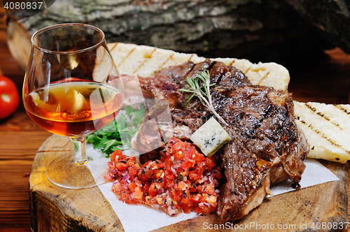 Image of juicy steak on the wooden background