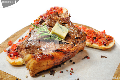 Image of fried steak on a wooden board