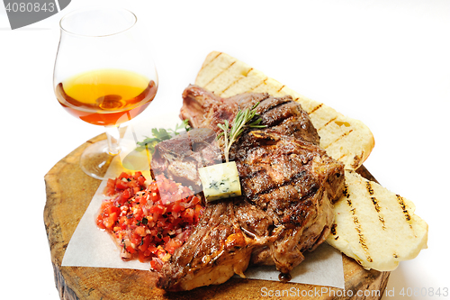 Image of fried steak on a wooden board