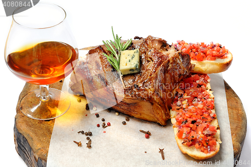 Image of fried steak on a wooden board