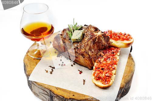 Image of fried steak on a wooden board